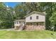 Charming home with a stone accent facade and wooden stairs leading to the front door at 2645 Holly Berry Trl, Snellville, GA 30039