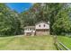 Charming home with a stone accent facade and wooden stairs surrounded by a green lawn at 2645 Holly Berry Trl, Snellville, GA 30039