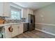 Updated kitchen features stainless steel appliances, white cabinets, and modern backsplash at 2645 Holly Berry Trl, Snellville, GA 30039