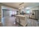 Bright kitchen with stainless appliances, gray and white backsplash, and light gray wide plank flooring at 2645 Holly Berry Trl, Snellville, GA 30039