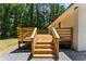 Backyard deck with wood railings and stairs leading to a gravel area and lush trees at 3013 Michael Sw Dr, Marietta, GA 30060
