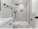 Modern bathroom with marble tile shower, sleek black hardware, and bright natural light from a window at 3013 Michael Sw Dr, Marietta, GA 30060