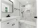 Modern bathroom with marble tile shower, sleek black hardware, and bright natural light from a window at 3013 Michael Sw Dr, Marietta, GA 30060
