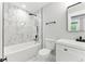 Stylish bathroom featuring marble tiling, modern fixtures, and a clean, bright design at 3013 Michael Sw Dr, Marietta, GA 30060