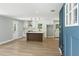 Bright, open-concept living space featuring modern kitchen with island and hardwood floors at 3013 Michael Sw Dr, Marietta, GA 30060