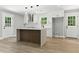 Bright open kitchen with a central island, stainless appliances, and wood-look flooring at 3013 Michael Sw Dr, Marietta, GA 30060