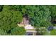 Aerial shot of a home nestled among mature trees with ample parking and a well-maintained roof at 3597 Embry Cir, Atlanta, GA 30341