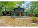 A well-maintained yard showcases the sunroom extension with outdoor patio space at 3597 Embry Cir, Atlanta, GA 30341