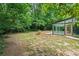 Expansive backyard featuring a modern sunroom with glass walls and doors, perfect for enjoying the serene outdoor setting at 3597 Embry Cir, Atlanta, GA 30341