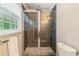 A stylish bathroom with a glass enclosed shower featuring dark tile, and modern fixtures at 3597 Embry Cir, Atlanta, GA 30341