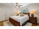 A cozy bedroom features a wooden bed frame, ceiling fan, and neutral decor at 3597 Embry Cir, Atlanta, GA 30341
