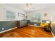 A charming bedroom features hardwood floors, wainscoting, and ample natural light at 3597 Embry Cir, Atlanta, GA 30341