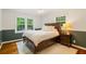 A bright bedroom has a wooden bed frame, a modern ceiling fan, and natural light at 3597 Embry Cir, Atlanta, GA 30341