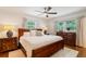 Spacious bedroom with hardwood floors, ceiling fan, and large windows providing ample natural light at 3597 Embry Cir, Atlanta, GA 30341