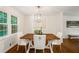 Well-lit dining room with a modern chandelier, a wooden table, and views to the exterior at 3597 Embry Cir, Atlanta, GA 30341