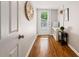 Inviting entryway with built-in bench, coat hooks, hardwood floors, and view of the door to the yard at 3597 Embry Cir, Atlanta, GA 30341