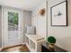 Inviting entryway with built-in bench, coat hooks, and view of door and yard at 3597 Embry Cir, Atlanta, GA 30341