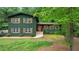 Charming two-story home featuring wood shutters, a well-maintained lawn, and mature shade trees at 3597 Embry Cir, Atlanta, GA 30341