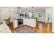 The kitchen features stainless steel appliances, granite countertops, wood floors, and a view into the dining room at 3597 Embry Cir, Atlanta, GA 30341