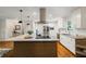 Bright kitchen boasts stainless appliances, a large island, granite countertops, and wood floors at 3597 Embry Cir, Atlanta, GA 30341