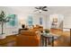 Bright living room with hardwood floors, a ceiling fan, and natural light from three large windows at 3597 Embry Cir, Atlanta, GA 30341