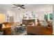 Open concept living and kitchen area with hardwood floors, modern lighting, and stainless steel appliances at 3597 Embry Cir, Atlanta, GA 30341