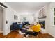 Charming living room features brick fireplace, hardwood floors, and stylish seating creating a cozy ambiance at 3597 Embry Cir, Atlanta, GA 30341
