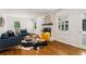 Bright living room with white brick fireplace, hardwood floors, and stylish decor creating a cozy ambiance at 3597 Embry Cir, Atlanta, GA 30341