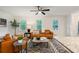 Bright living room with hardwood floors, a ceiling fan, and natural light from three large windows at 3597 Embry Cir, Atlanta, GA 30341