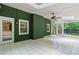 Bright sunroom with exposed brick, fan, skylight, windows and white tile creating a cozy ambiance at 3597 Embry Cir, Atlanta, GA 30341