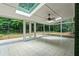Bright sunroom with skylight and fan providing natural lighting, views of trees and sliding glass doors at 3597 Embry Cir, Atlanta, GA 30341