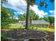 The peaceful backyard featuring a mature tree, a lawn and a landscaped area with rocks at 4016 Dover Ave, Alpharetta, GA 30009