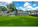 Picturesque backyard featuring a lush lawn, patio area, and mature trees, creating a serene outdoor space at 4016 Dover Ave, Alpharetta, GA 30009