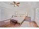 Spacious primary bedroom with tray ceilings, hardwood floors, and plenty of natural light at 4016 Dover Ave, Alpharetta, GA 30009
