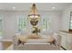 This dining room features a chandelier, natural light, and shutters, creating an inviting atmosphere at 4016 Dover Ave, Alpharetta, GA 30009