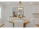 Elegant dining room with stylish chandelier, decorative mirror, and seating for four at 4016 Dover Ave, Alpharetta, GA 30009