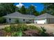Inviting single-story home featuring a two-car garage, well-kept landscaping, and a circular driveway at 4016 Dover Ave, Alpharetta, GA 30009