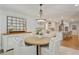 Dining room leading to a bright kitchen with white cabinets and stainless steel appliances at 4016 Dover Ave, Alpharetta, GA 30009