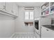 Neat laundry room with patterned tile flooring, upper cabinets, and modern appliances at 4016 Dover Ave, Alpharetta, GA 30009