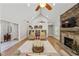 Open living room with vaulted ceiling and stone fireplace, perfect for gatherings at 4016 Dover Ave, Alpharetta, GA 30009