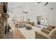 Bright living room boasts stone fireplace, high ceilings with fan, and view to the dining and kitchen areas at 4016 Dover Ave, Alpharetta, GA 30009