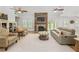 Spacious living room features a stone fireplace, ceiling fans, and bright natural light at 4016 Dover Ave, Alpharetta, GA 30009