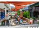 Charming outdoor seating area with colorful decor, tables, and sun shades for a delightful dining experience at 4016 Dover Ave, Alpharetta, GA 30009
