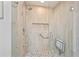 Shower showcasing light stone-look tile, mosaic accents, and a built-in shower seat at 4016 Dover Ave, Alpharetta, GA 30009