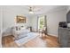 Cozy sitting room with hardwood floors, chaise lounge and neutral decor at 4016 Dover Ave, Alpharetta, GA 30009
