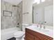 Bathroom features updated tile tub-shower surround and floating vanity at 404 Hawkstone Way, Alpharetta, GA 30022