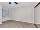 Bedroom with wood-look floors, large window, and mirrored closet at 404 Hawkstone Way, Alpharetta, GA 30022
