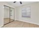 Bedroom featuring updated floors, ceiling fan, and mirrored closet at 404 Hawkstone Way, Alpharetta, GA 30022