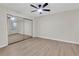 Bedroom features updated floors, ceiling fan, and mirrored closet at 404 Hawkstone Way, Alpharetta, GA 30022