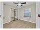 Bedroom with new floors, ceiling fan, and mirrored closet doors at 404 Hawkstone Way, Alpharetta, GA 30022